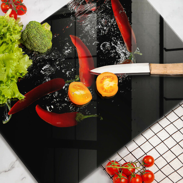 Chopping board glass Chili peppers in water