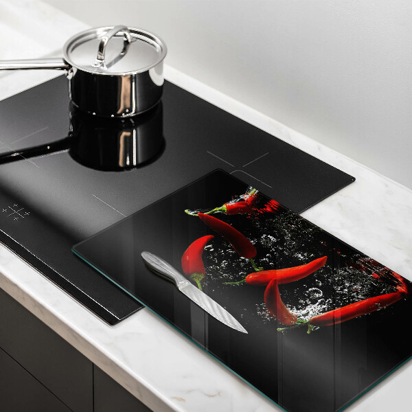 Chopping board glass Chili peppers in water