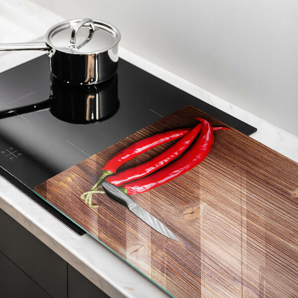 Glass cutting board Chili peppers on wood
