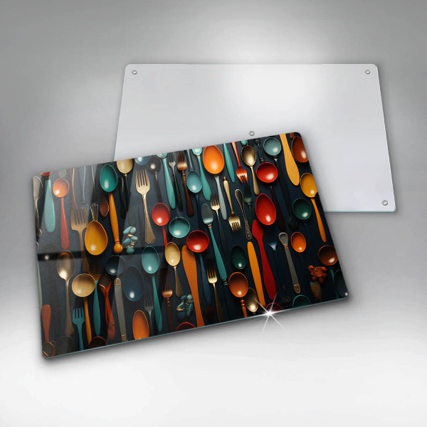 Chopping board glass Colorful spoons and forks