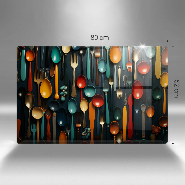 Chopping board glass Colorful spoons and forks