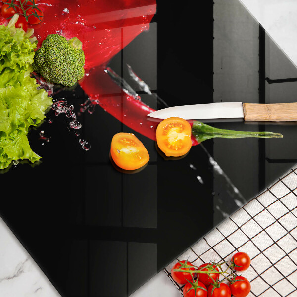 Chopping board glass Red peppers in water