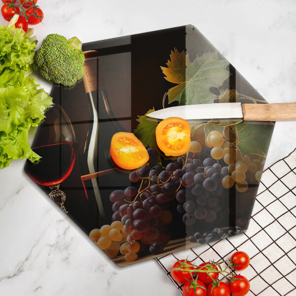 Chopping board A glass of wine and grapes