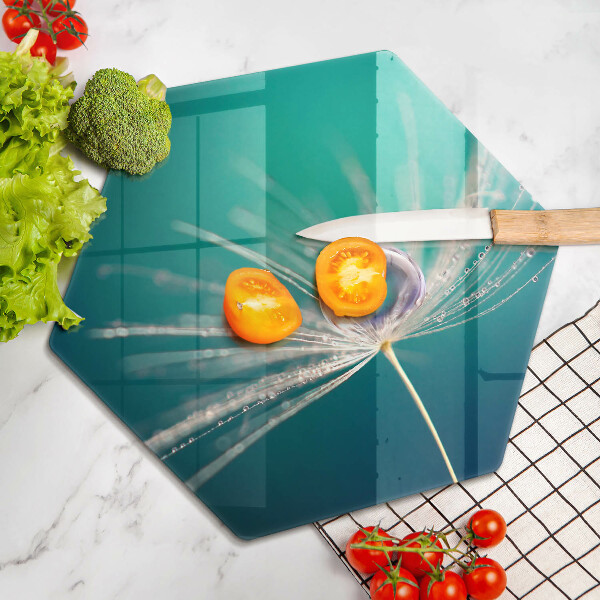Chopping board glass Dew on a dandelion