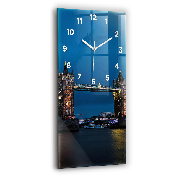 Modern vertical wall clock Tower Bridge London at night