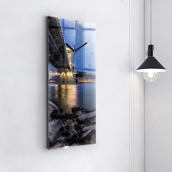 Modern vertical wall clock Rocky shore under the bridge