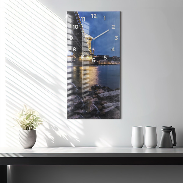 Modern vertical wall clock Rocky shore under the bridge
