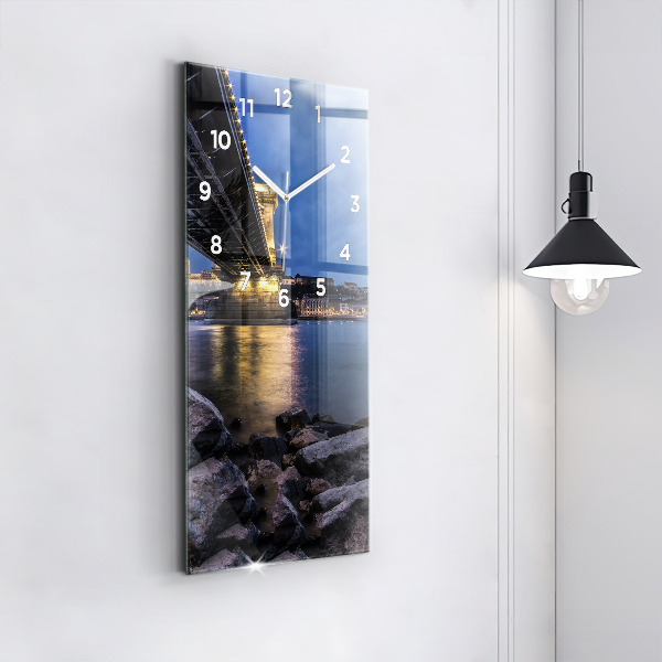 Modern vertical wall clock Rocky shore under the bridge