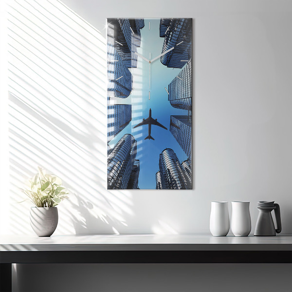 Modern vertical wall clock Airplane over buildings