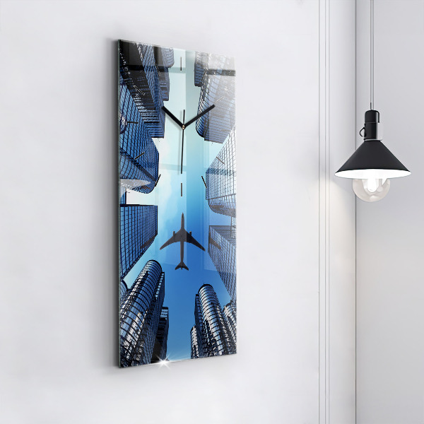 Modern vertical wall clock Airplane over buildings