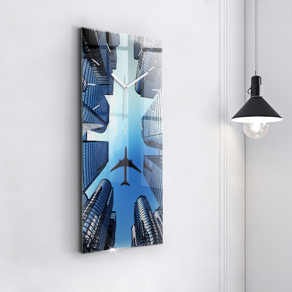 Modern vertical wall clock Airplane over buildings