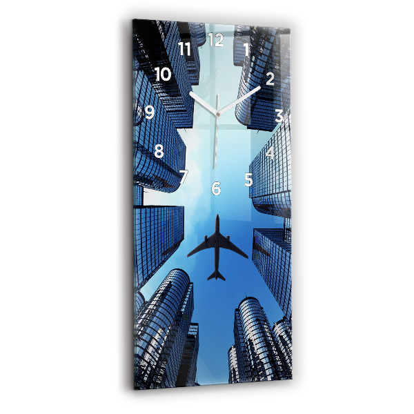 Modern vertical wall clock Airplane over buildings