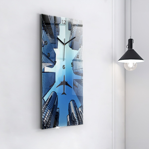 Modern vertical wall clock Airplane over buildings