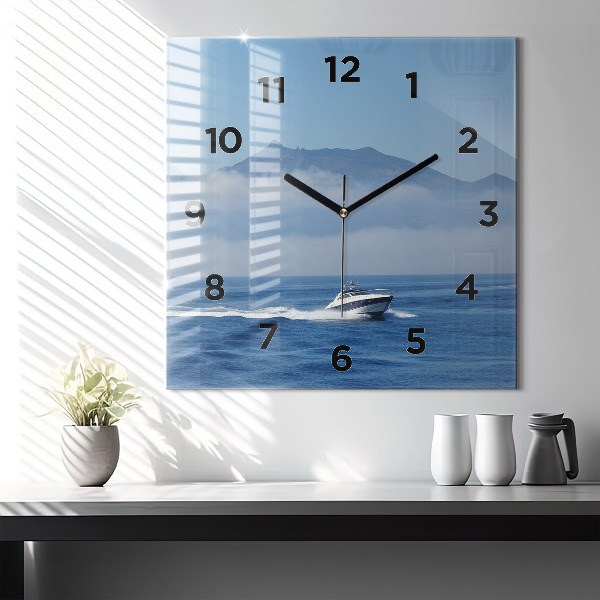 Square glass wall clock A boat floating on the ocean