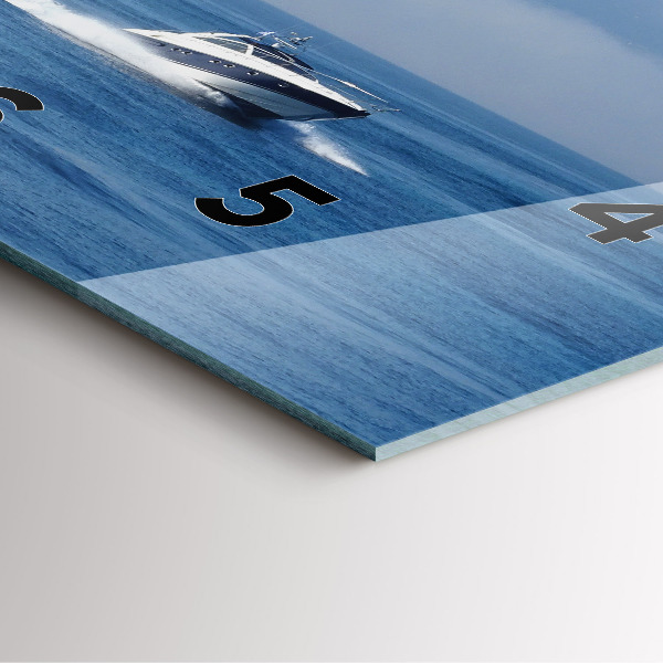 Square glass wall clock A boat floating on the ocean