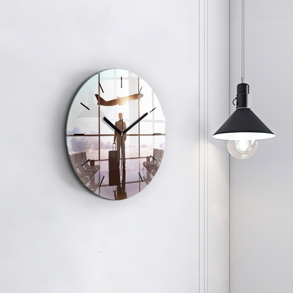 Round glass clock Man at the airport