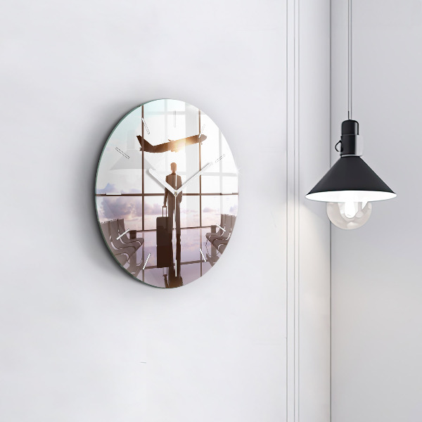Round glass clock Man at the airport