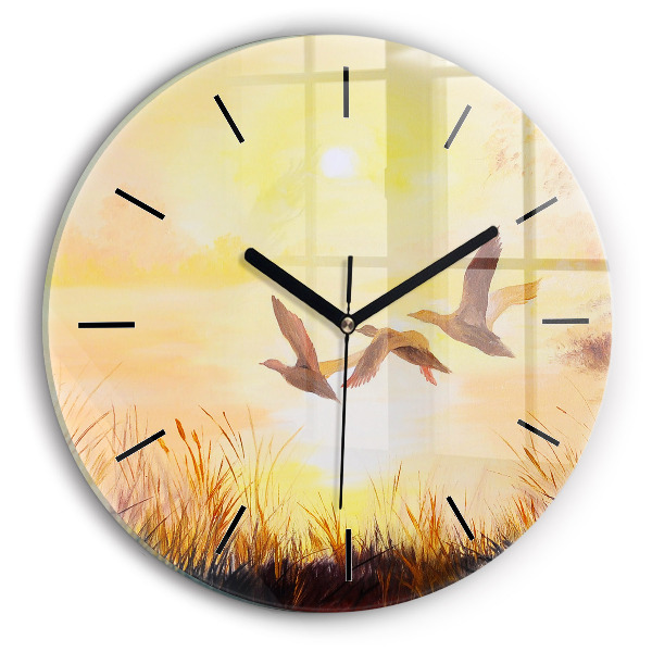 Round glass clock Cranes at sunset