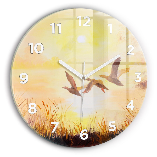 Round glass clock Cranes at sunset
