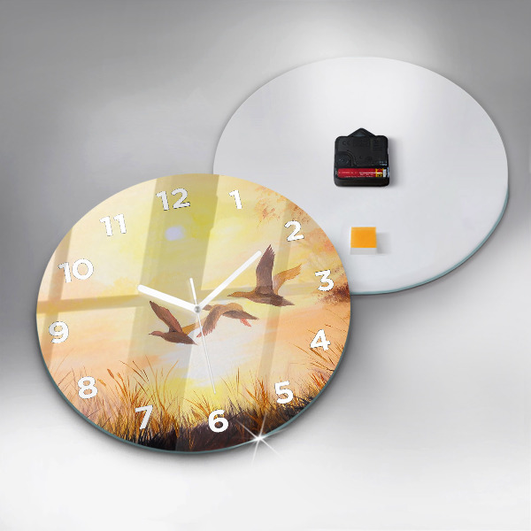 Round glass clock Cranes at sunset
