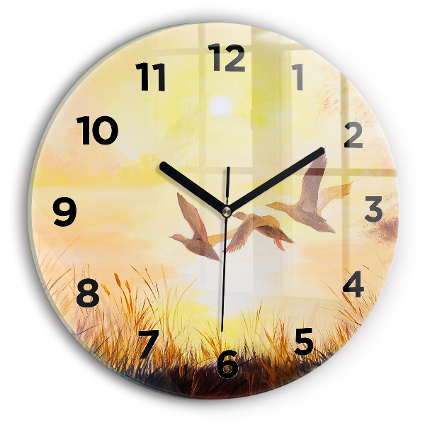 Round glass clock Cranes at sunset