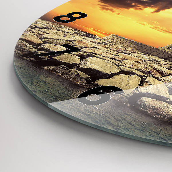 Round glass clock Lighthouse on the water