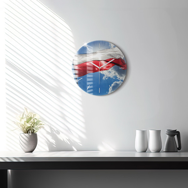 Round glass clock The Polish flag against the sky