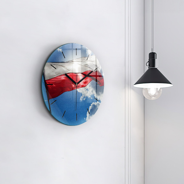 Round glass clock The Polish flag against the sky