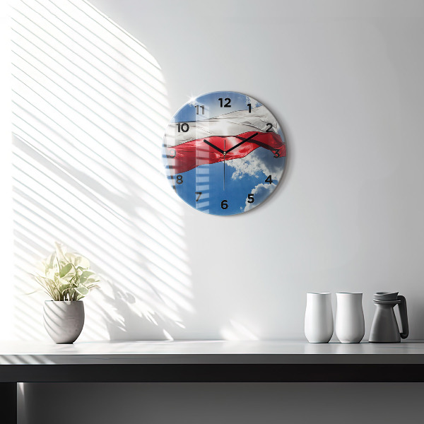 Round glass clock The Polish flag against the sky