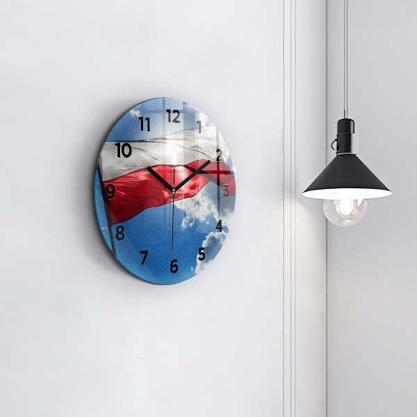 Round glass clock The Polish flag against the sky