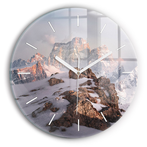 Round glass clock A mountain covered in snow