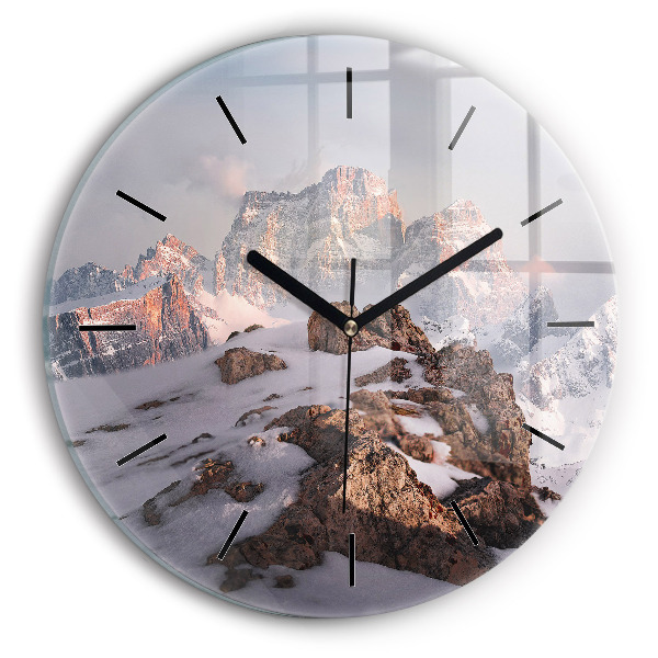 Round glass clock A mountain covered in snow