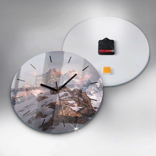 Round glass clock A mountain covered in snow