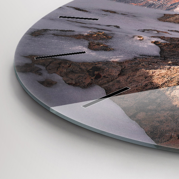 Round glass clock A mountain covered in snow