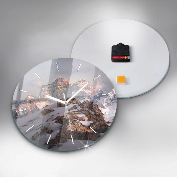 Round glass clock A mountain covered in snow