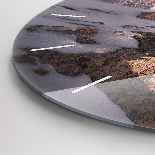 Round glass clock A mountain covered in snow