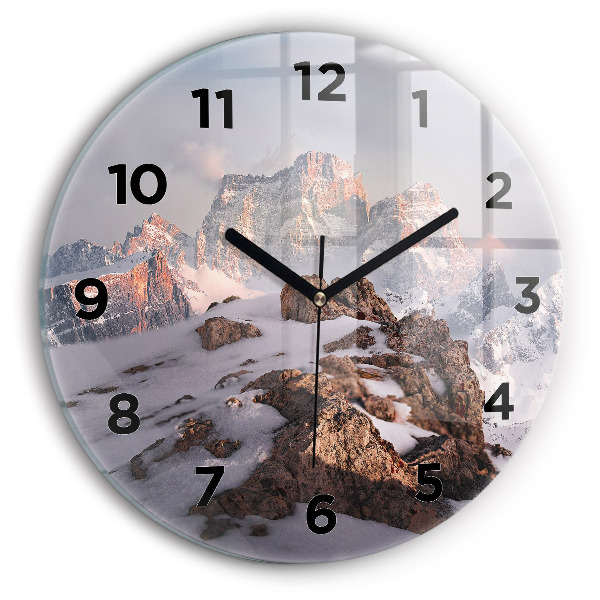 Round glass clock A mountain covered in snow