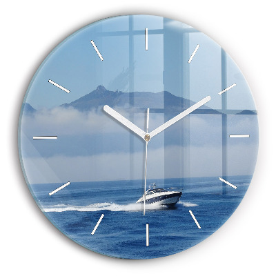 Round glass clock A boat floating on the ocean