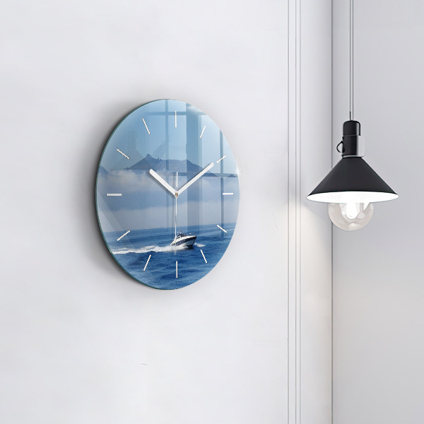 Round glass clock A boat floating on the ocean
