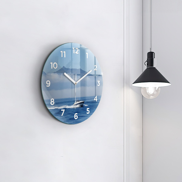 Round glass clock A boat floating on the ocean