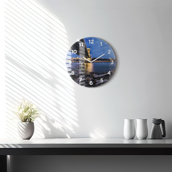 Round glass clock Rocky shore under the bridge