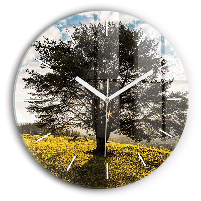 Round glass clock A tree on a hill