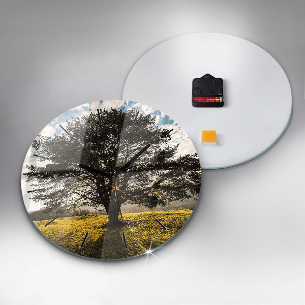 Round glass clock A tree on a hill