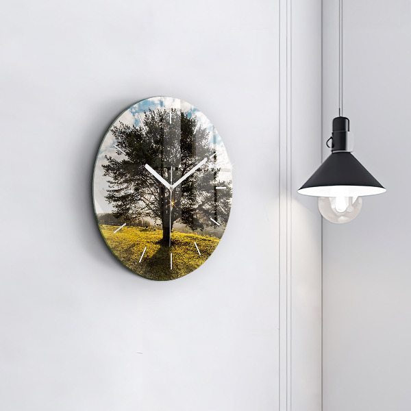 Round glass clock A tree on a hill