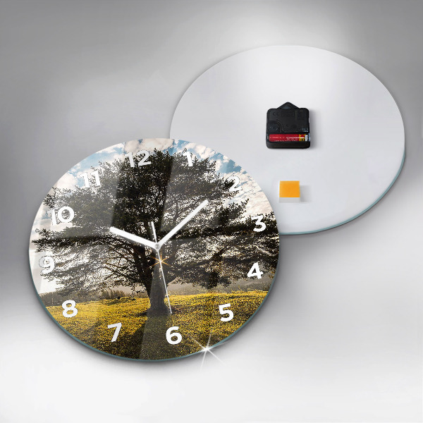 Round glass clock A tree on a hill