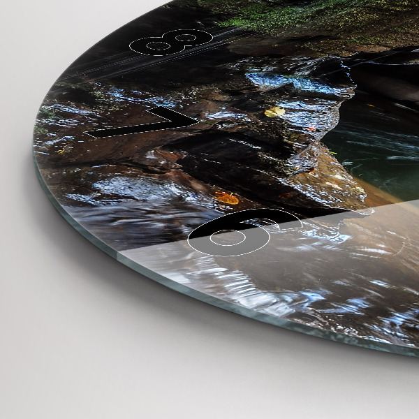 Round glass clock Waterfall and rocks of Iceland