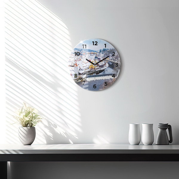 Round glass clock Panorama of the city in winter