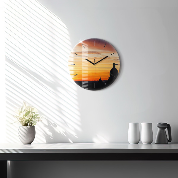 Round glass clock Building and sunset