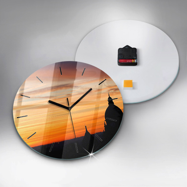 Round glass clock Building and sunset