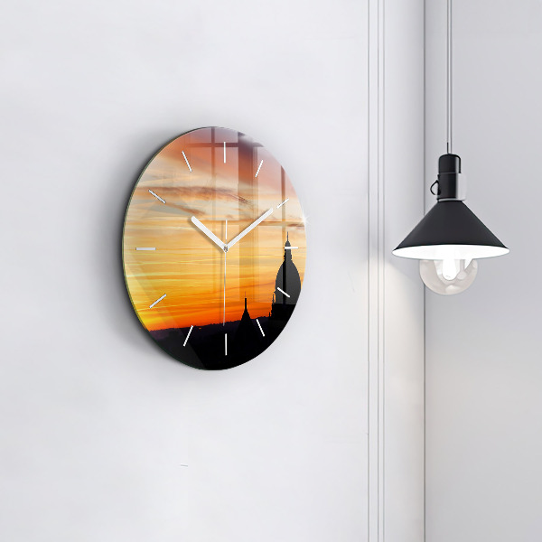 Round glass clock Building and sunset
